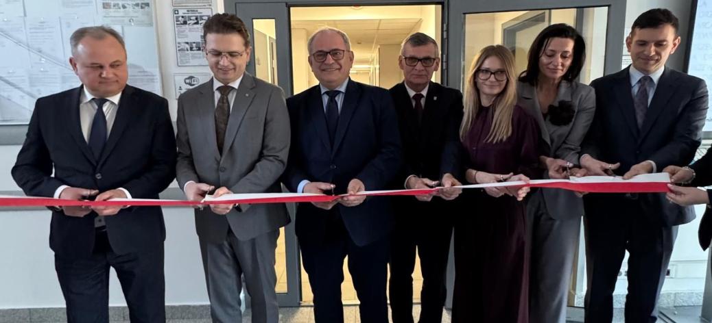 Symbolicznego przecięcia wstęgi dokonuje siedem osób - od lewej: Członek Zarządu Województwa Łódzkiego Artur Ostrowski, II Wicewojewoda Łódzki Grzegorz Majewski, I Wicewojewoda Łódzki Marek Mazur, Burmistrz Drzewicy Janusz Reszelewski, p.o. Zastępcy Dyrektora Wojewódzkiego Urzędu Pracy w Łodzi Aneta Dziemdziela, Przewodnicząca Rady Miejskiej w Drzewicy Dorota Wiktorowicz oraz p.o. Zastępcy Dyrektora Regionalnego Centrum Polityki Społecznej w Łodzi Oskar Kuliński.