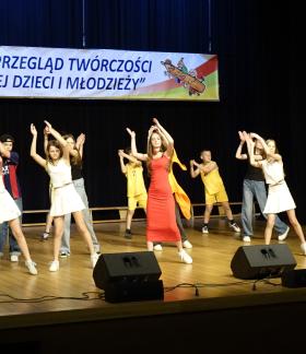 Na scenie w układzie tanecznym kilkunastoosobowa grupa uczniów SP w Domasznie