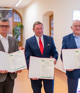 Trzej uczestnicy uroczystości w Rektoracie Uniwersytetu Łódzkiego prezentują podpisane porozumienie. Pierwszy z lewej Burmistrz Drzewicy Janusz Reszelewski