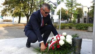 Burmistrz Drzewicy Janusz Reszelewski składa wiązankę kwiatów pod Pomnikiem Pamięci