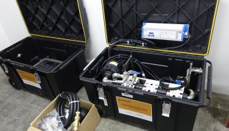 Mobilna stacja uzdatniania wody złożona w dwóch plastikowych pojemnikach i kartonowym pudełku